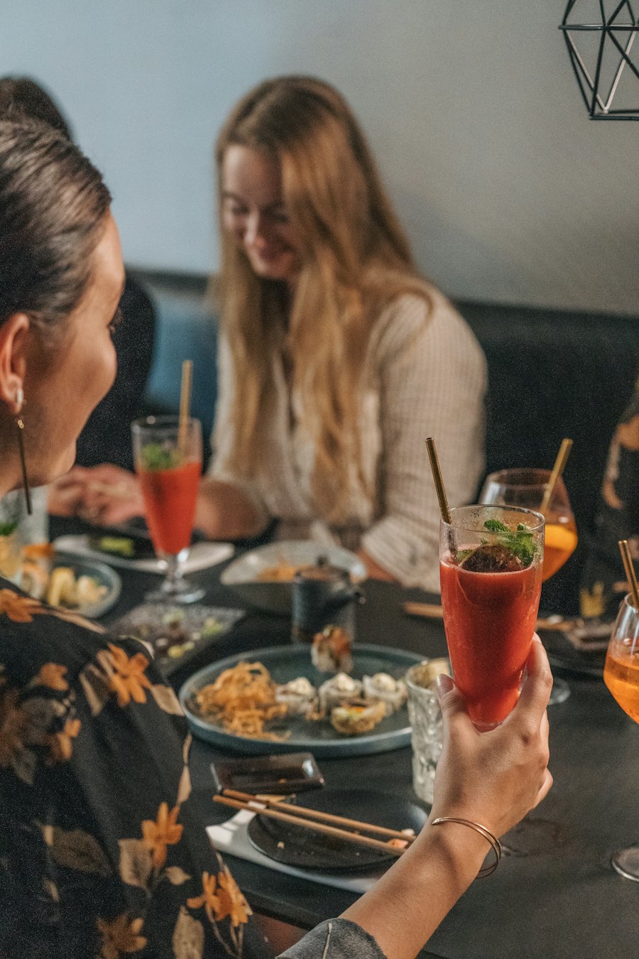 Two people talking over drinks and small plates